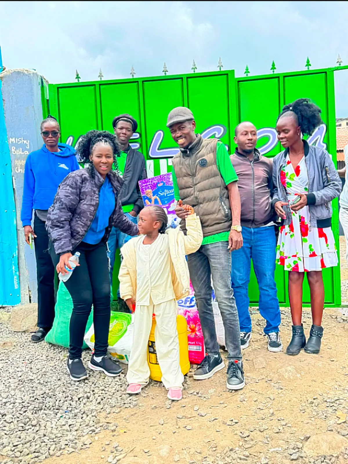 Nyasuba Golden Pillars volunteers delivering food and supplies at a community gate